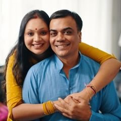 Lovely Indian Couple Looking Happy Portrait of lovely Indian couple embracing and smiling at camera while spending time at home